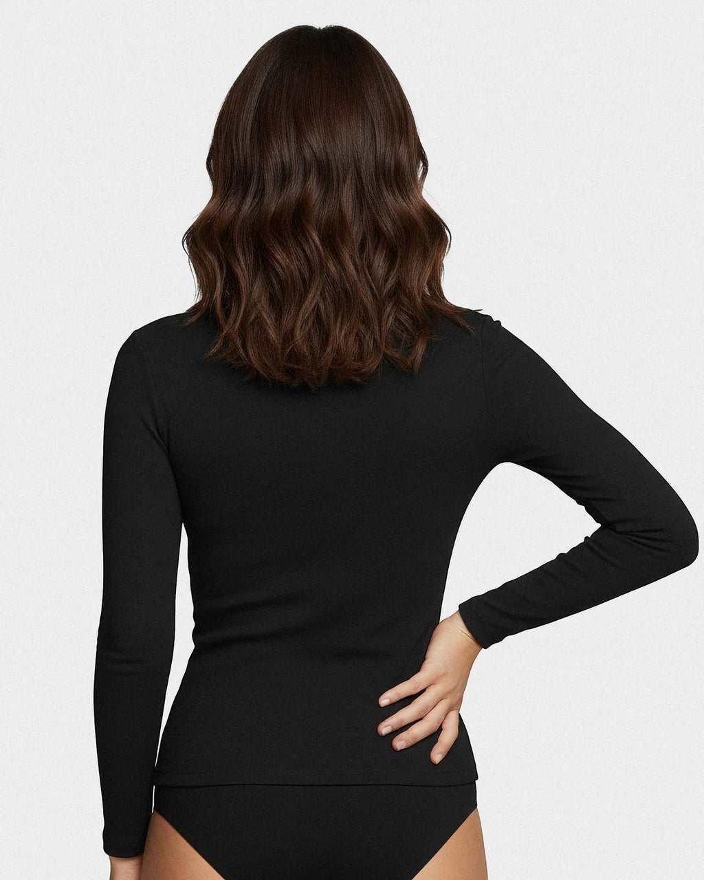 Maison Sarava women's black long-sleeve crew neck top in Lyocell and Merino wool, detail view.