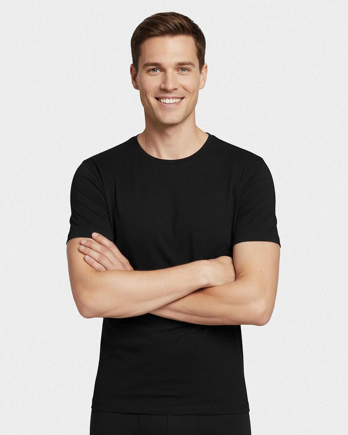 Maison Sarava men's black short-sleeved Merino wool t-shirt with a round neck. Model with arms crossed.