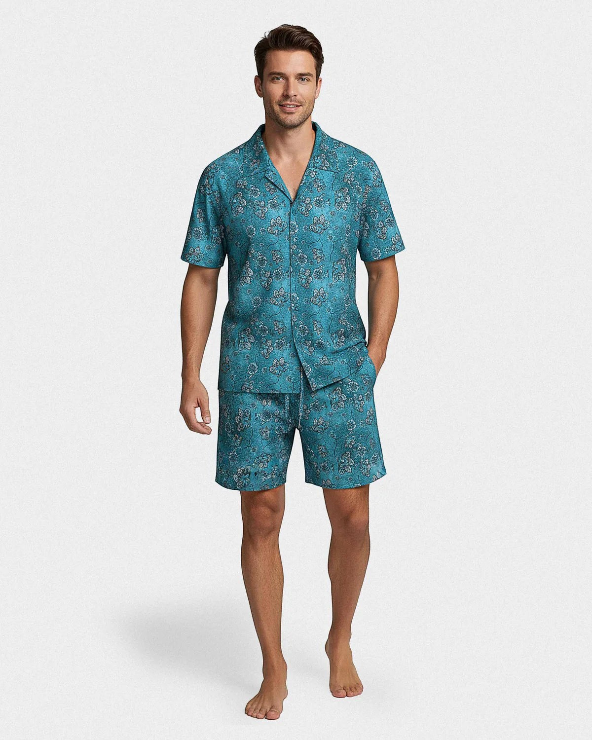 Maison Sarava men's aqua green lyocell lounge set with tropical floral print. Short sleeves, lapel collar, button front shirt and drawstring shorts.