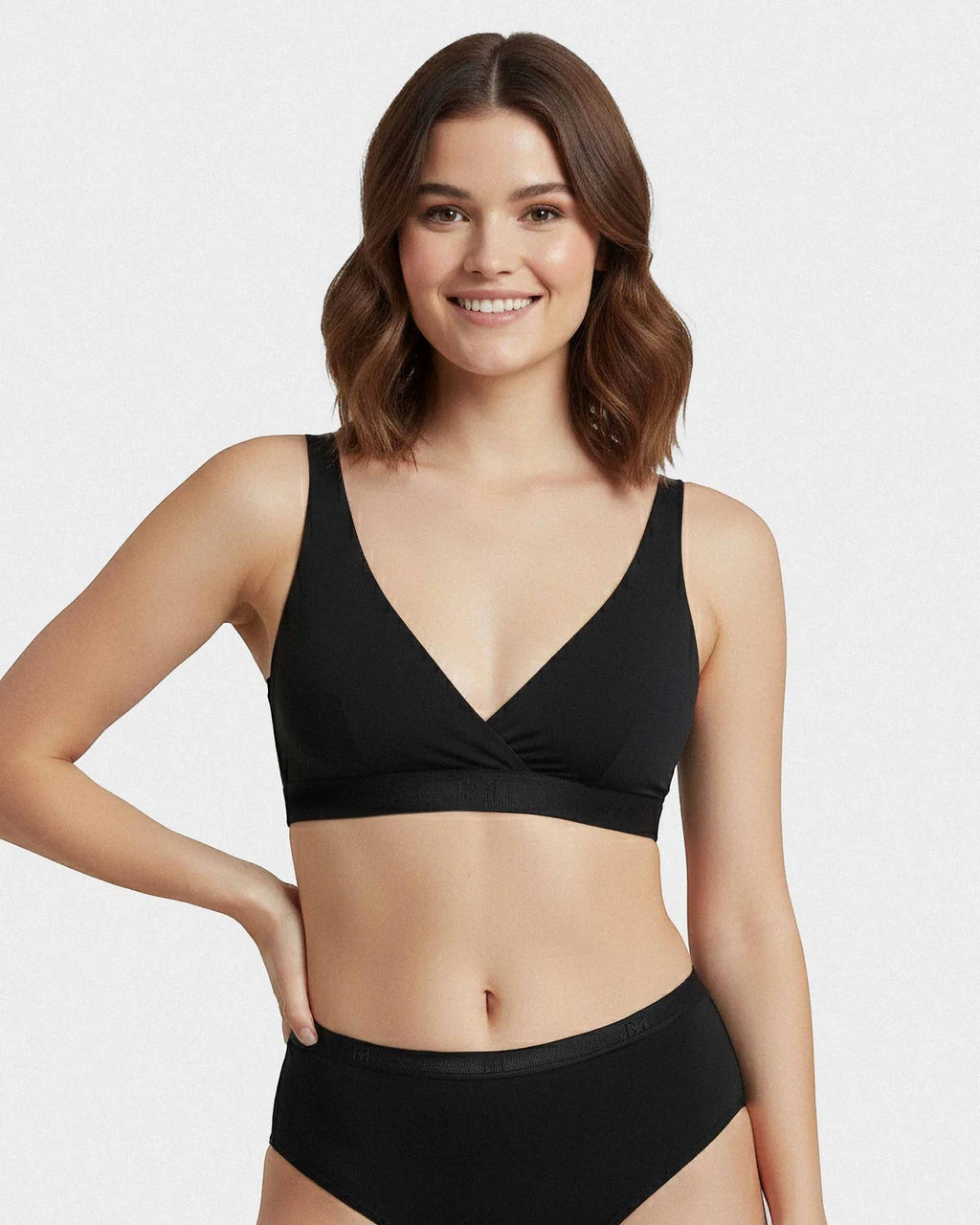 Maison Sarava black triangular non-wired bra in Lyocell with adjustable straps and a comfortable band. Model is wearing matching briefs.