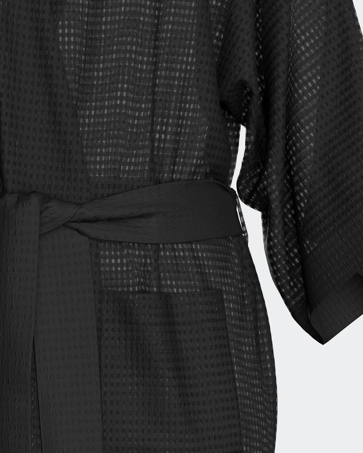 Maison Sarava black waffle knit kimono robe with wide sleeves and self-tie belt, featuring two side pockets.