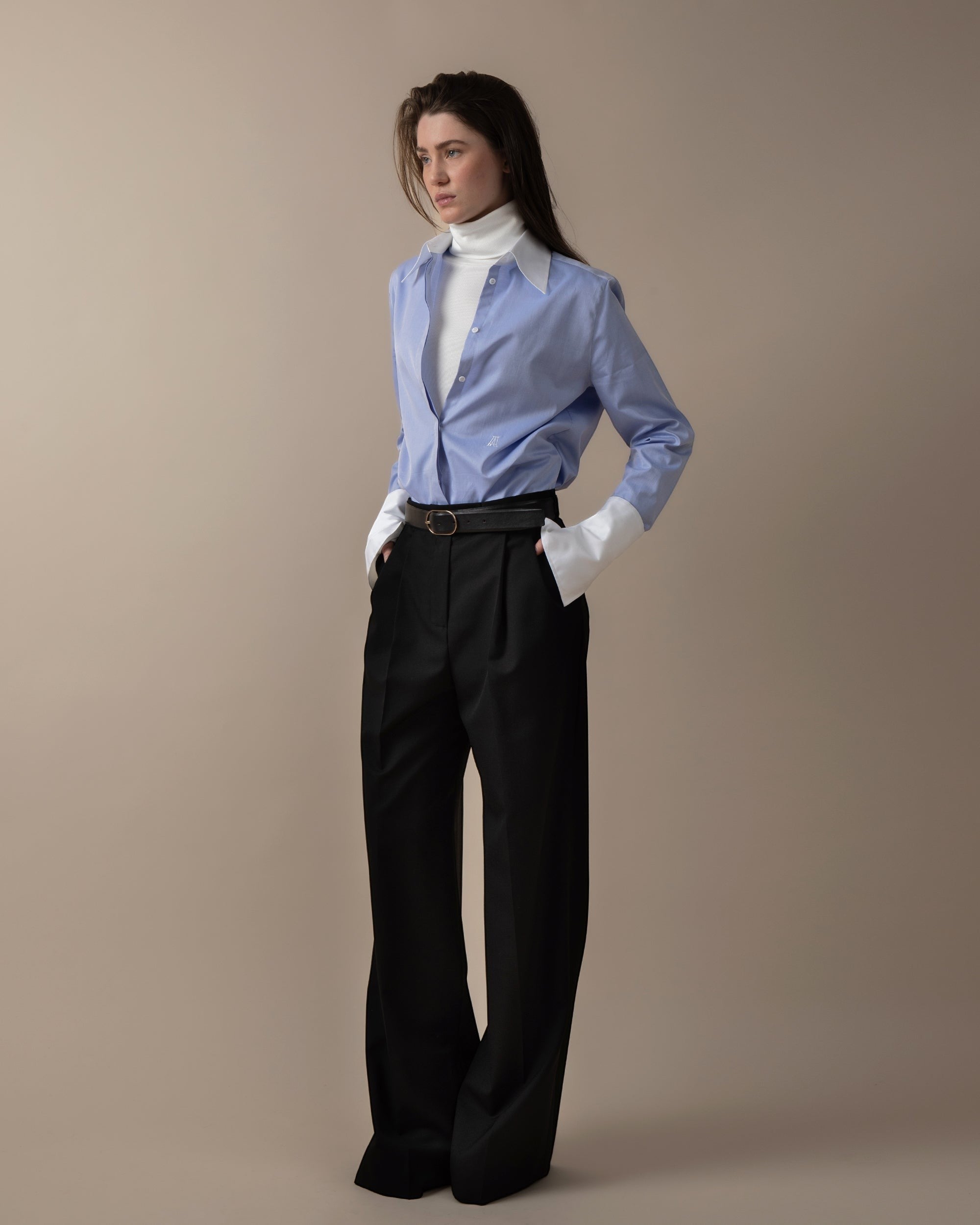 Maison Sarava women's blue fitted shirt with white contrast collar and cuffs, hidden buttons, and back pleat detail.