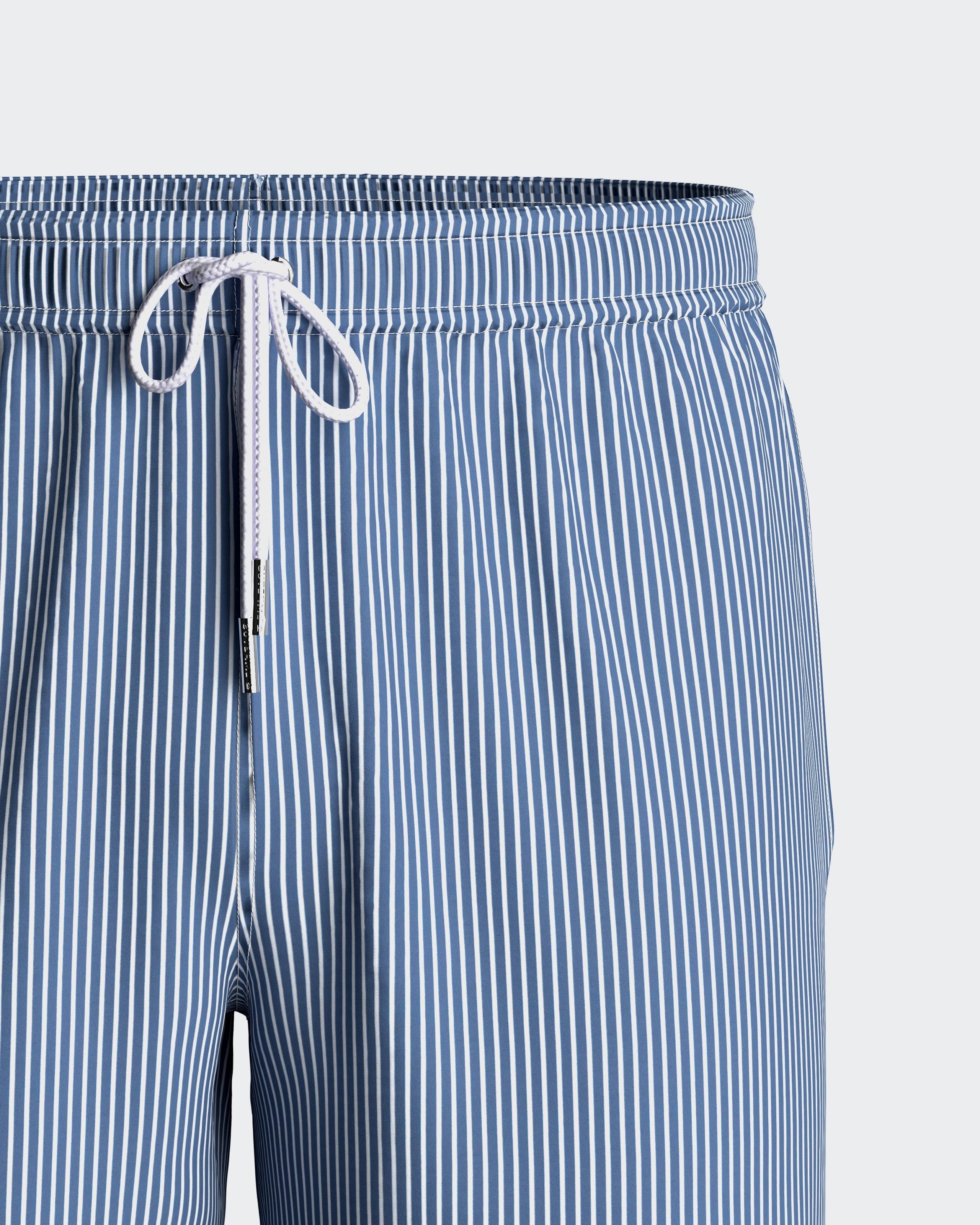 Maison Sarava blue and white striped men's swim shorts with drawstring and pockets.