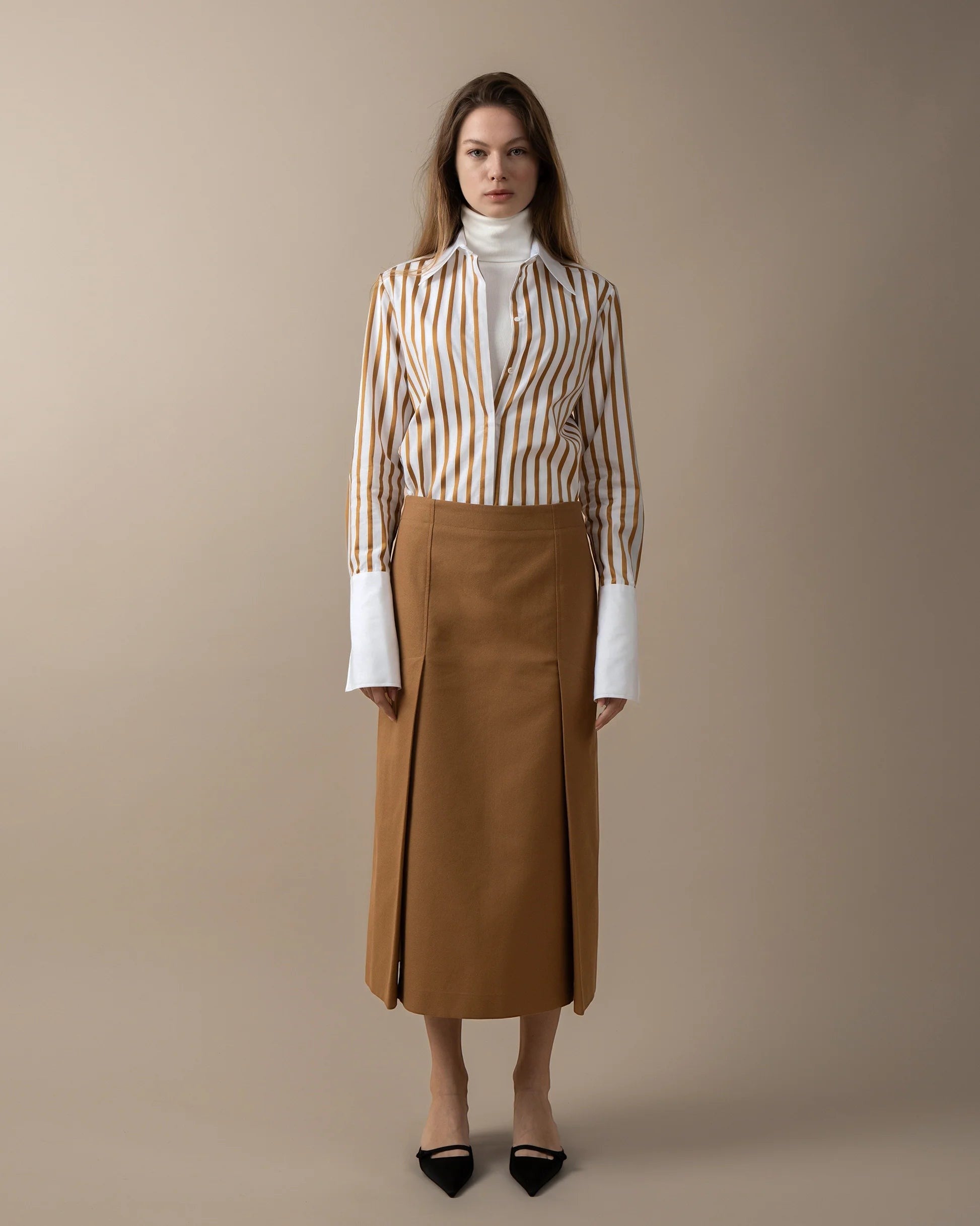 Maison Sarava women's straight-fit midi skirt in camel brown with double front vent and invisible back zip.