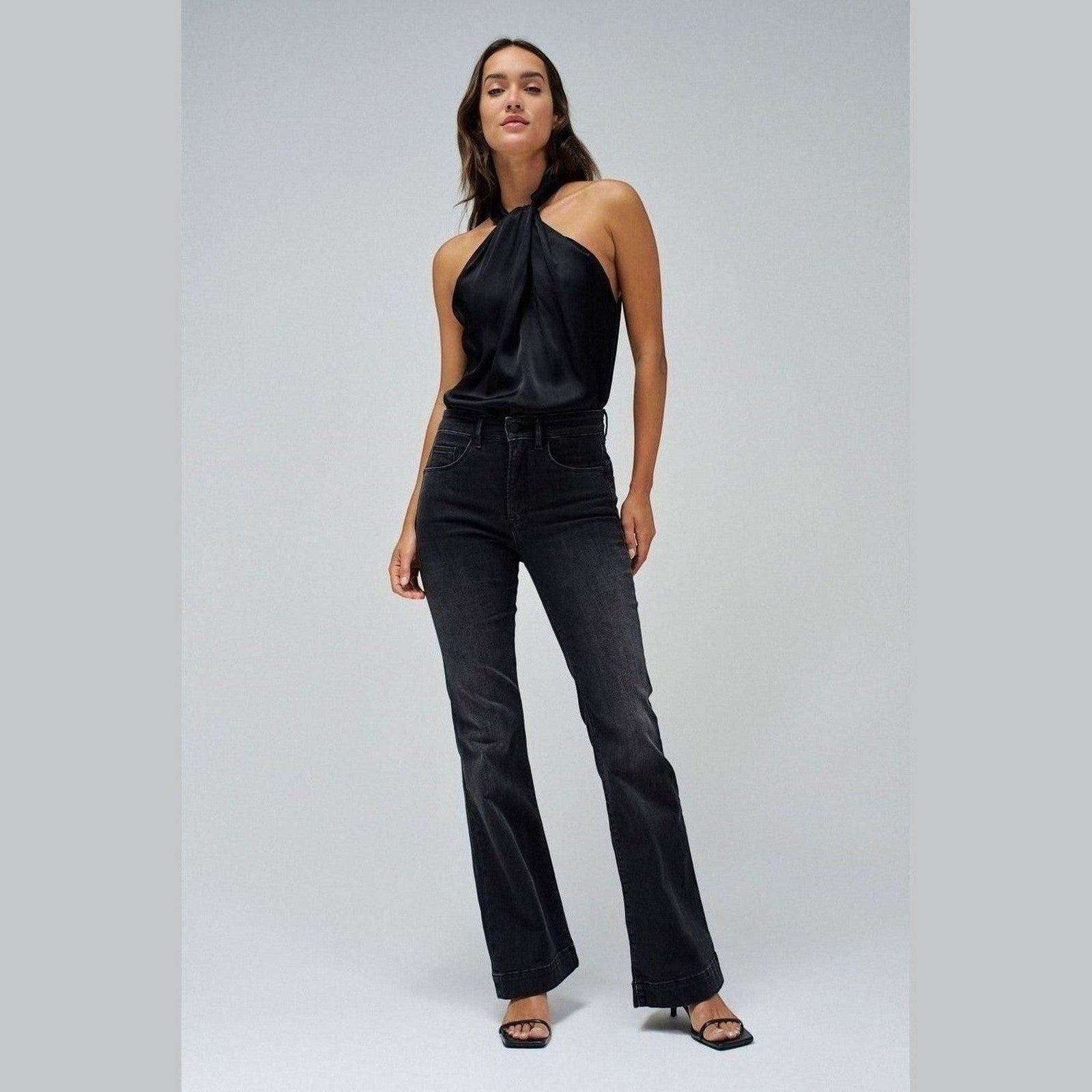 Maison Sarava charcoal wash high waisted flare denim jeans on a model.