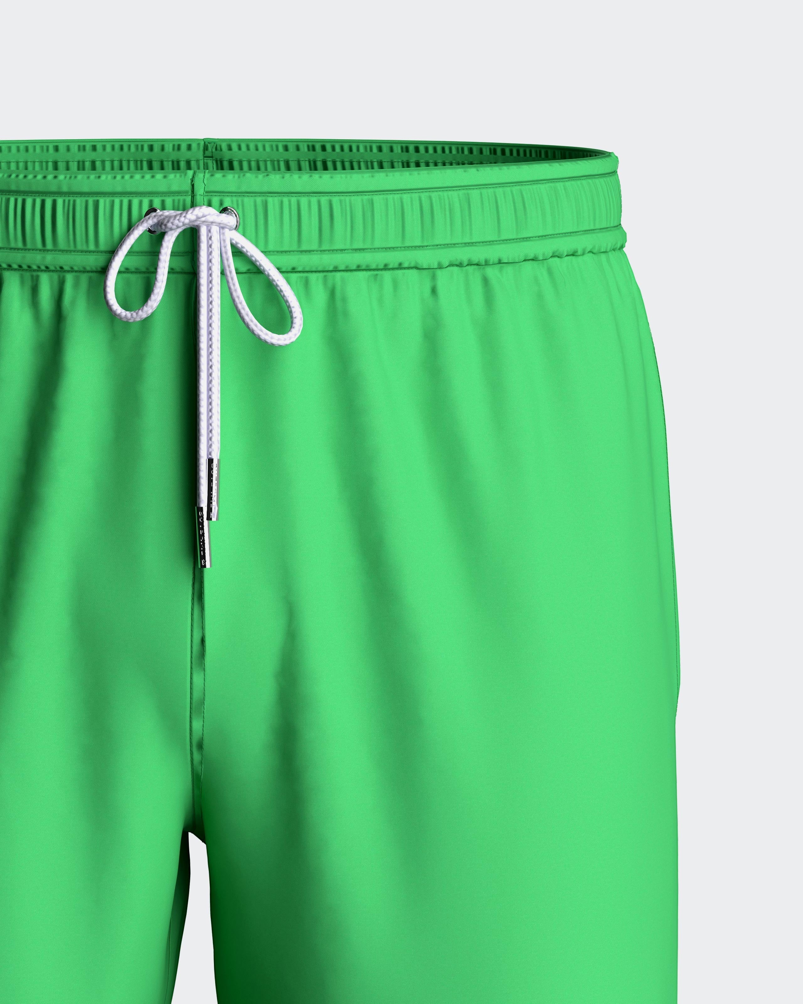 Maison Sarava green polyester men's swim shorts with adjustable drawstring waist and side pockets.