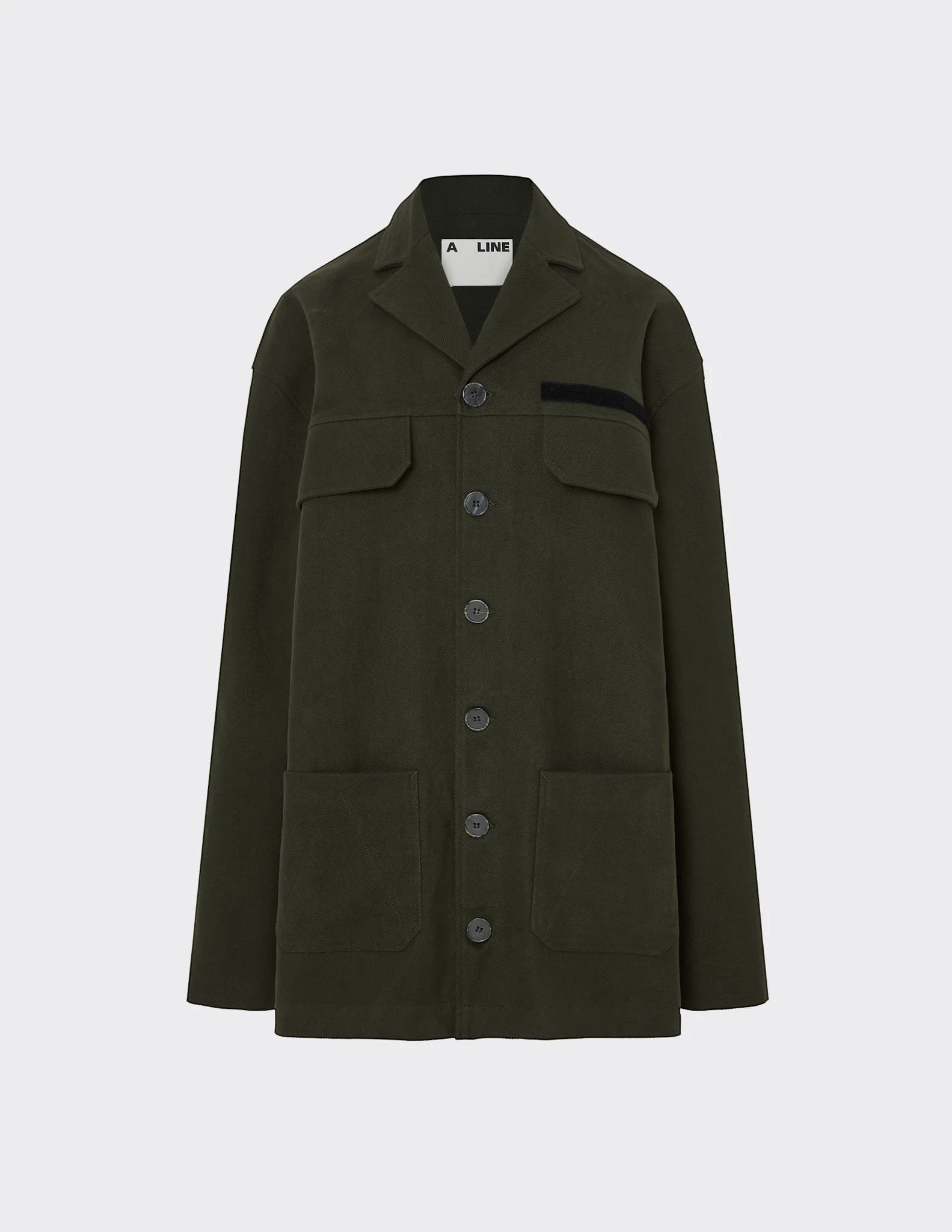 Maison Sarava dark green oversized utility jacket with peaked lapels, four patch pockets, and elbow patches.