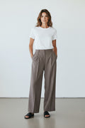 Maison Sarava grey wide leg pleated trousers in a premium blend fabric, perfect for professional or casual wear.