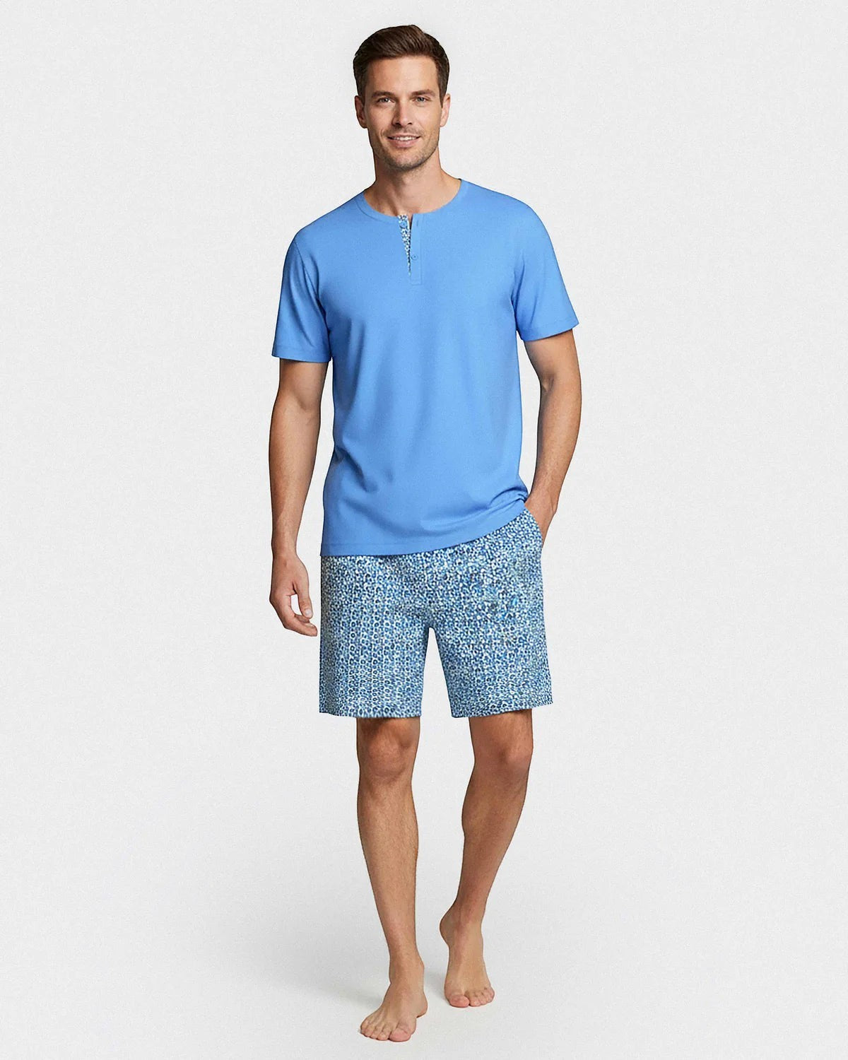 Maison Sarava men's blue cotton short sleeve lounge set with two-button placket and geometric print shorts.