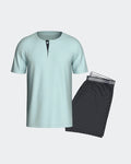 Maison Sarava men's light blue cotton short sleeve henley t-shirt with a navy micro logo pattern placket and matching navy micro logo pattern shorts with elastic waistband.
