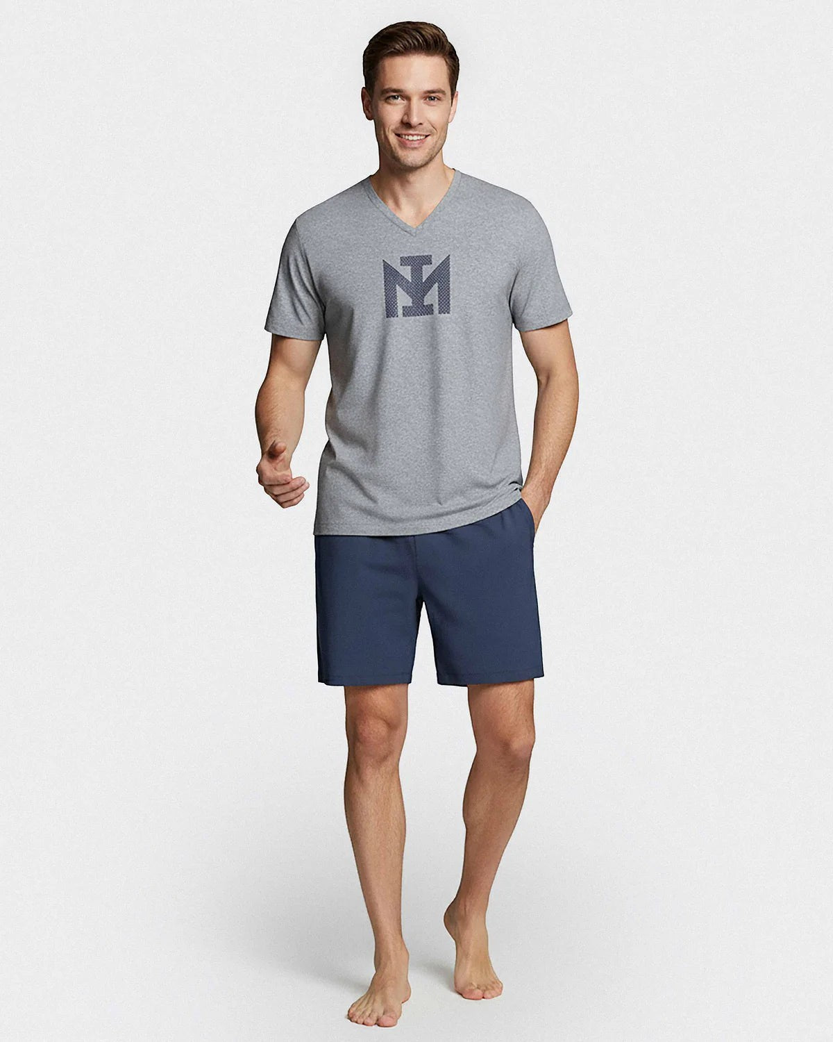 Maison Sarava men's grey V-neck cotton t-shirt with printed logo and navy blue shorts with elasticated waistband.