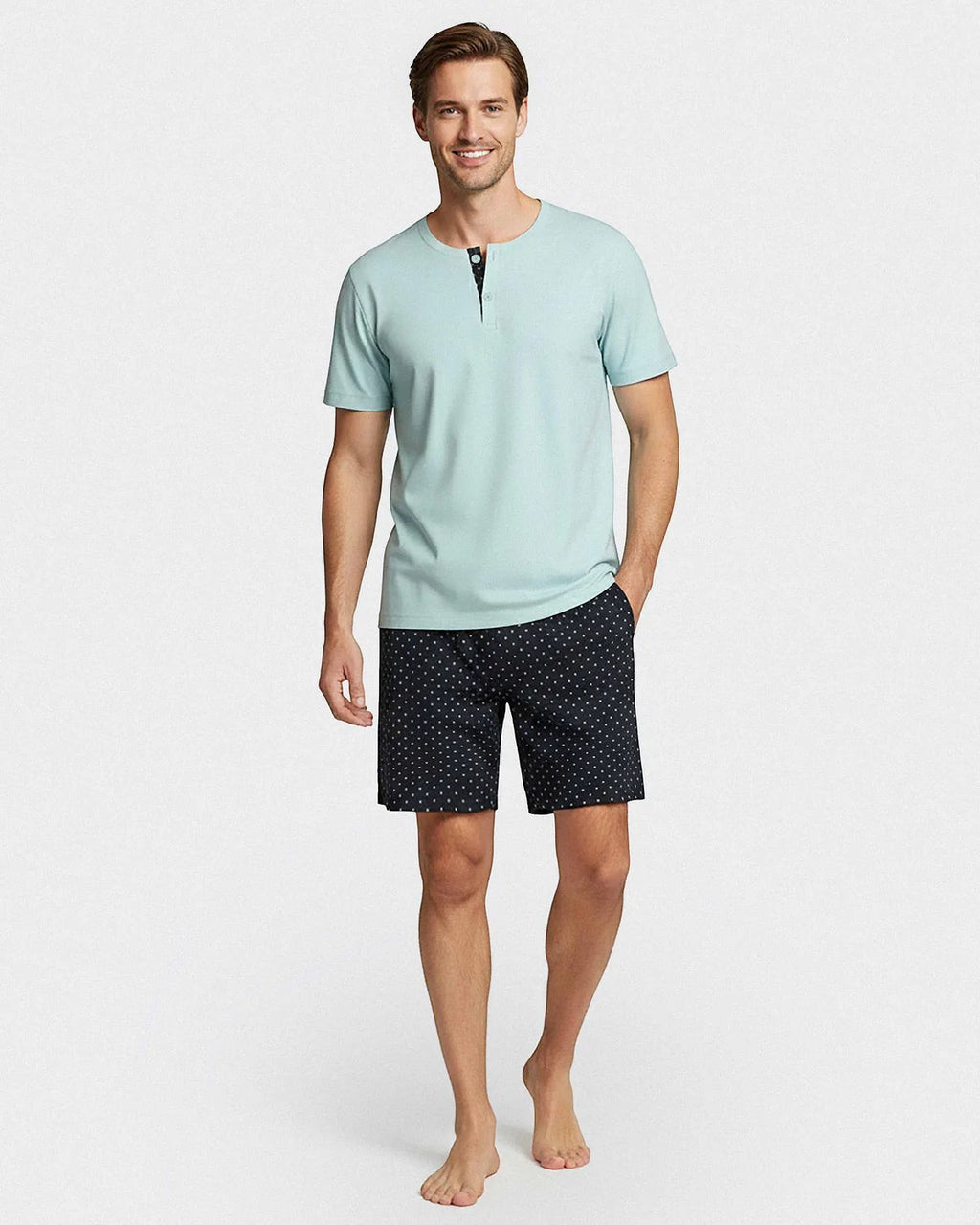Maison Sarava men's light blue cotton short sleeve lounge set with two-button placket and navy shorts with micro logo pattern.