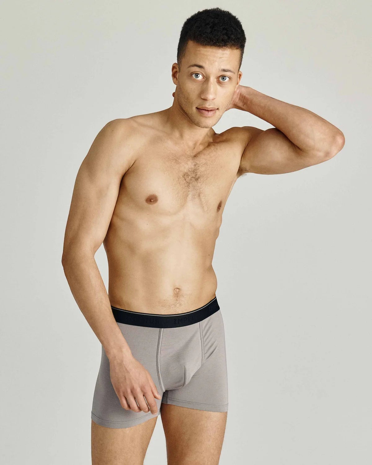 Maison Sarava men's grey cotton blend boxer briefs with black elastic waistband. Model posing against a light grey background.