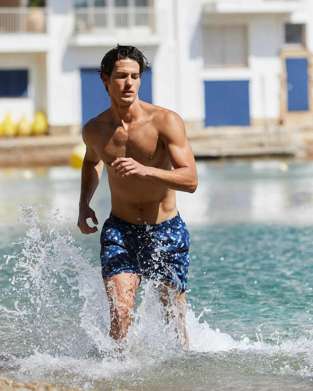 Maison Sarava men's navy blue floral print swim shorts with adjustable drawstring waist and inner mesh lining.