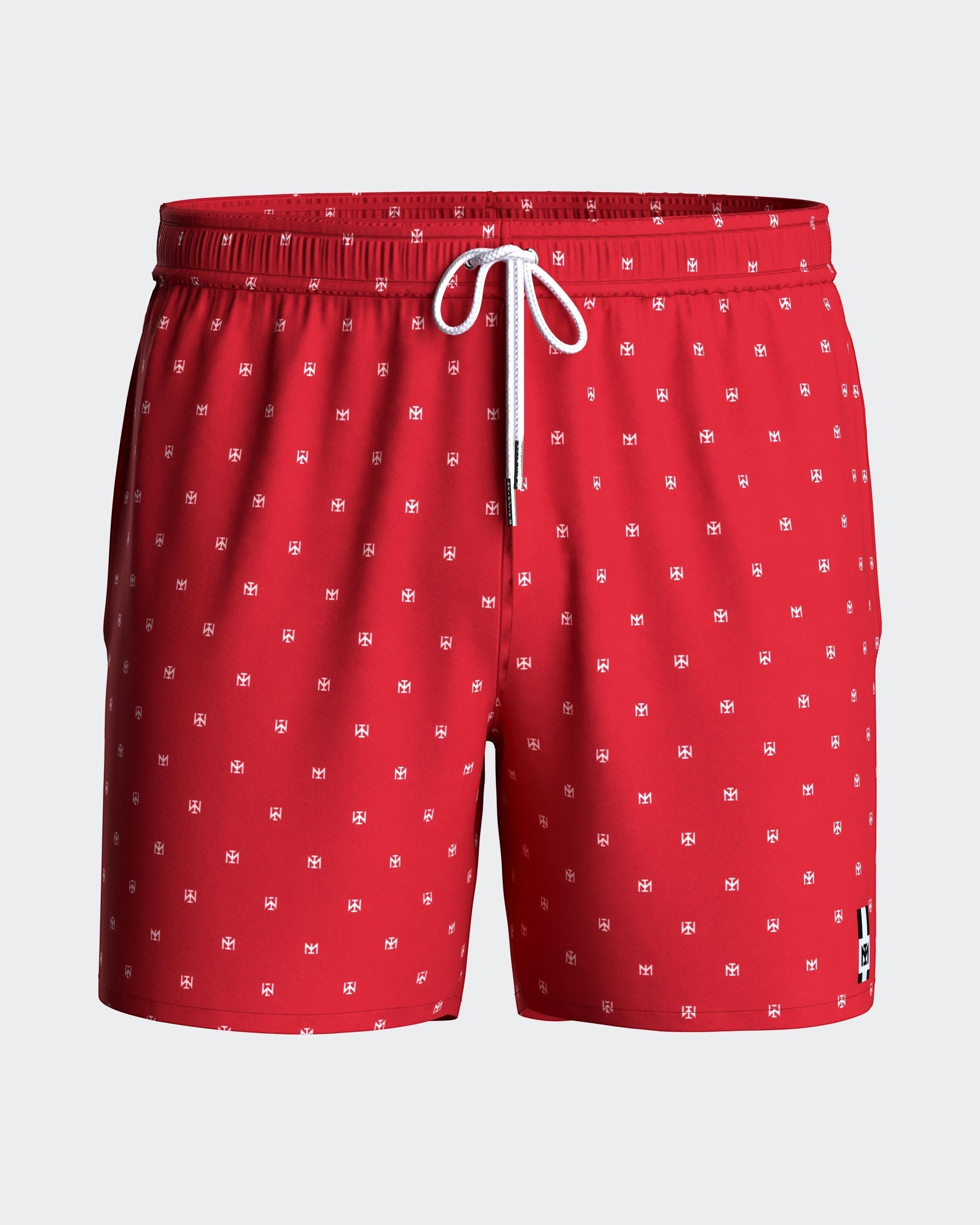 Maison Sarava red men's swim trunks with white micro-pattern logo, drawstring waist, side pockets, and inner mesh lining.