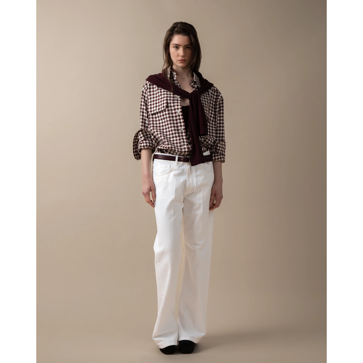 Maison Sarava women's oversized brown and white gingham western shirt with pointed collar, flap pockets, and dropped shoulders.