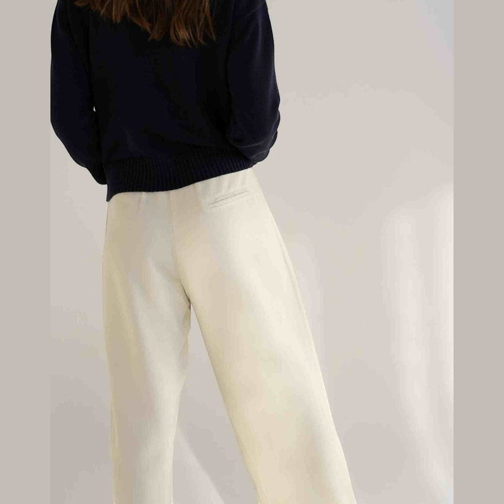 Maison Sarava white tencel wide-leg trousers with elastic waistband and front pleats.