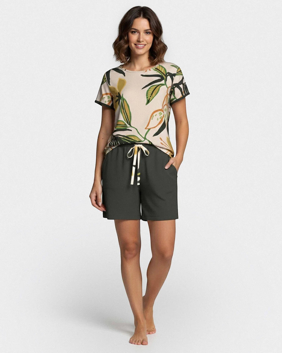 Maison Sarava women's beige short sleeve lounge set with tropical print top and dark green lyocell shorts.