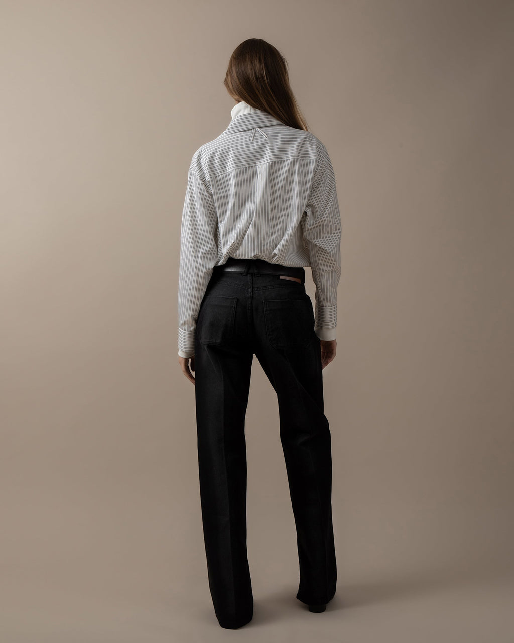 Maison Sarava women's oversized white and black pinstripe shirt with pointed collar and button cuffs.