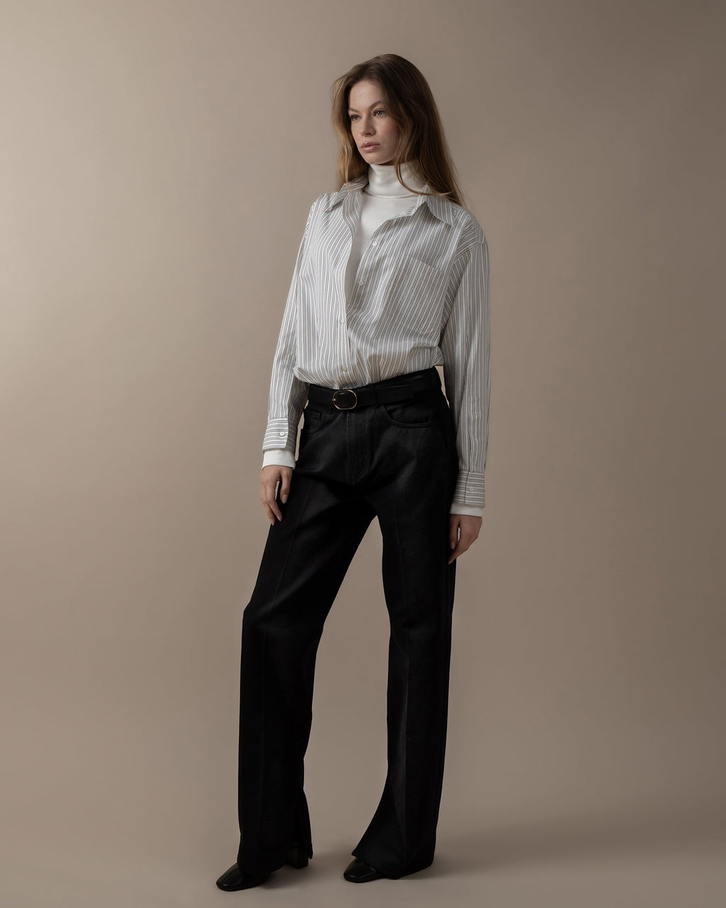 Maison Sarava women's oversized white and grey striped shirt with pointed collar, long sleeves, and button cuffs.