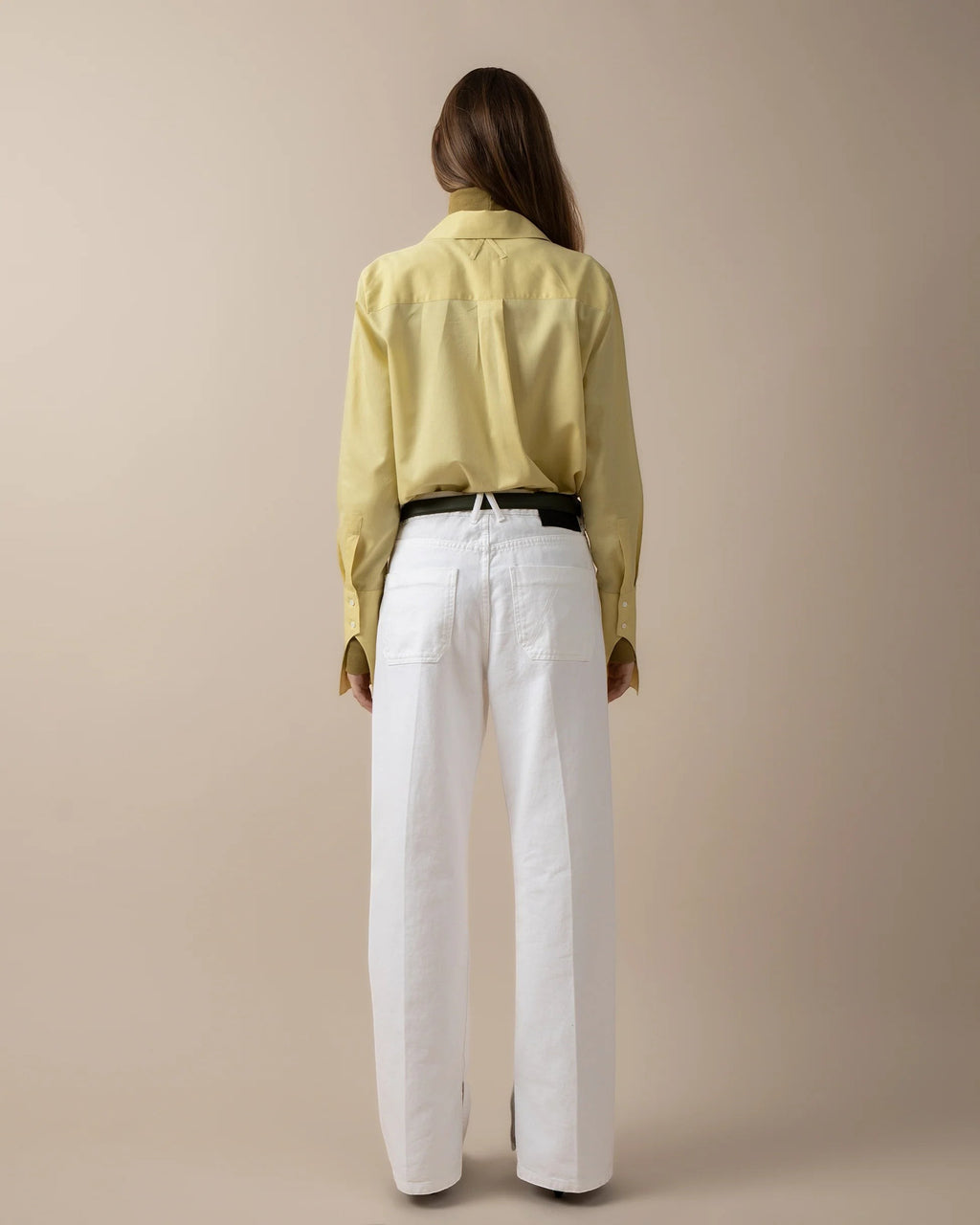 Maison Sarava women's pale yellow long-sleeve fitted shirt with pointed collar and box pleat back detail.